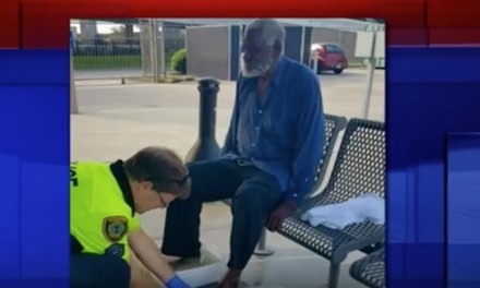 White cop washes feet of black, blind homeless man