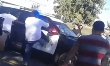 Mob attacks a CHP officer in his cruiser