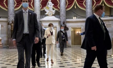 Called to vote, House members put in a masked appearance