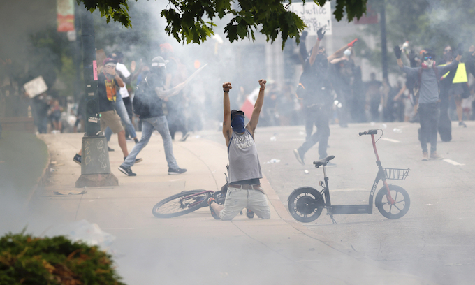 Federal judge orders Denver police to limit firing tear gas, projectiles at peaceful protesters